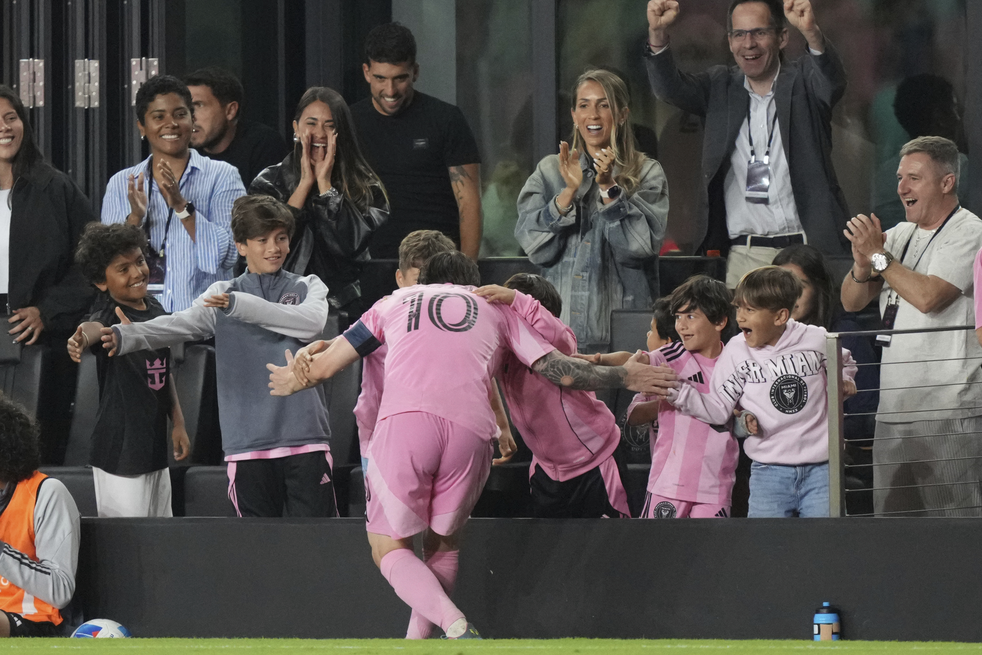 Lionel Messi slaps five with fans